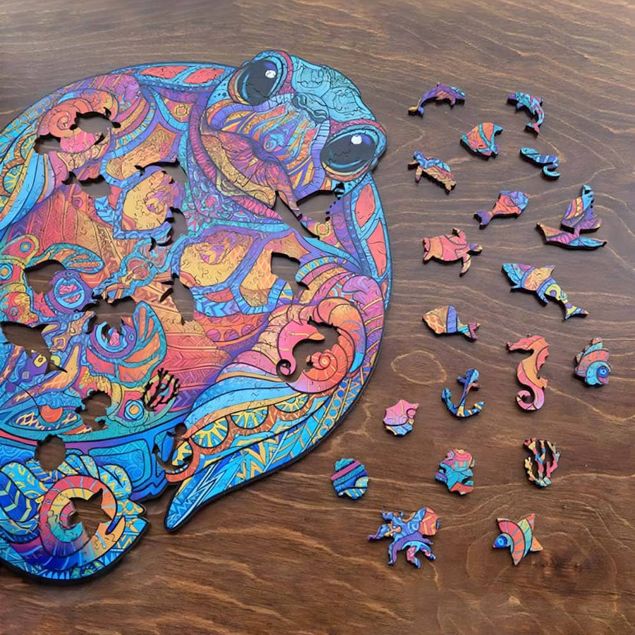 Colorful wooden puzzle of a turtle with intricate designs and various uniquely shaped pieces on a wooden surface.