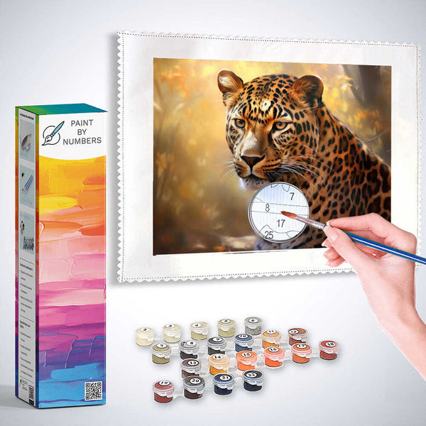 Paint by Numbers kit depicting a majestic leopard in an autumn forest, with paintbrush and paint pots included for creating the artwork.