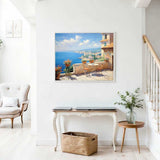 Paint by Numbers Mediterranean Reverie painting of a coastal view with vibrant flowers and sea on a wall in a bright, white room.