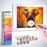 Paint by Numbers kit featuring an impressionist elephant artwork in vibrant oranges and reds, with paints and brush in the foreground