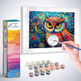 Paint by Numbers kit featuring a colorful owl artwork with vibrant spiraling patterns, surrounded by paint containers and a brush.