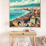 Wall art of coastal cityscape in Nizza, featuring rich orange hues and deep azure seas, displayed above a wooden desk in a modern room