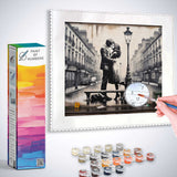 Paint by Numbers kit for Lovers in Paris showcasing a romantic scene with two lovers kissing on a Parisian street with paint supplies