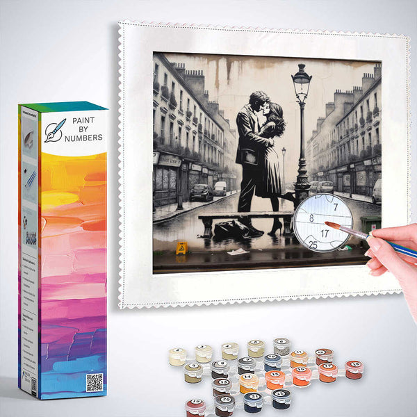 Paint by Numbers kit for Lovers in Paris showcasing a romantic scene with two lovers kissing on a Parisian street with paint supplies