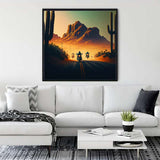 Diamond Painting - Asphalt Cowboy framed artwork featuring motorcyclist on a desert road at sunset displayed above a white sofa in modern living room.