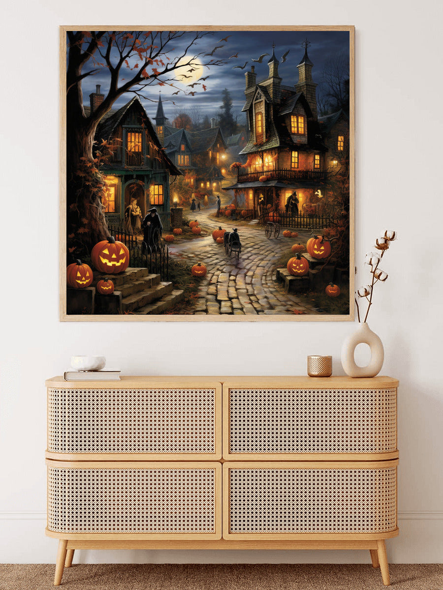 Paint by Numbers - Halloween village mystery artwork displayed on wall above wooden cabinet, with pumpkins and spooky village scene.