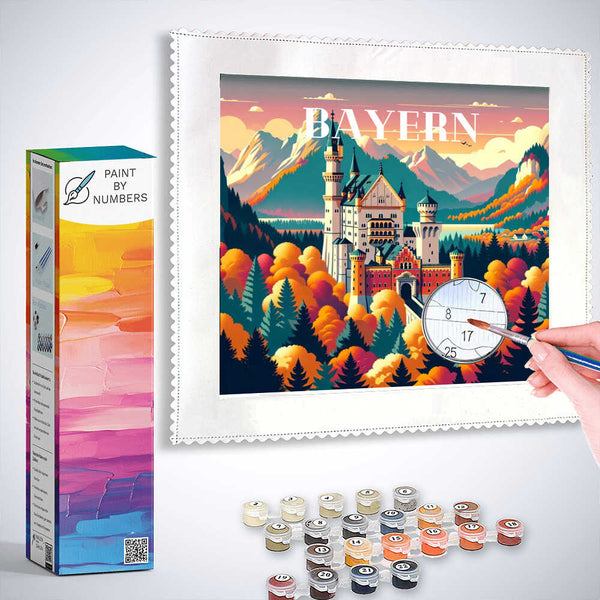 Paint by Numbers Bavarian Dreams kit featuring Neuschwanstein Castle, autumn forest, and Alps with painting supplies and hand in progress
