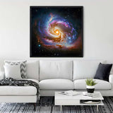 Galaxy-themed diamond painting displayed in a modern living room with a white sofa and decor.