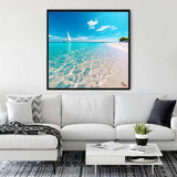 Diamond Painting - Coastal Magic displayed in living room, showing a serene beach scene with a sailboat and turquoise waters.