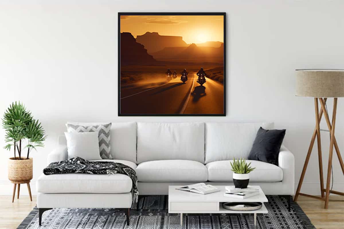 Living room with white sofa, modern decor, and framed diamond painting of motorcyclists on a sunlit road