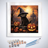 Paint by Numbers Witch Kitten with pumpkins and haunted house in background, complete paint set with brushes and palette displayed.