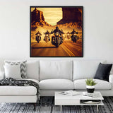 Modern living room with a stylish sofa, wall art of bikers on a desert road, indoor plant, and contemporary decor elements.