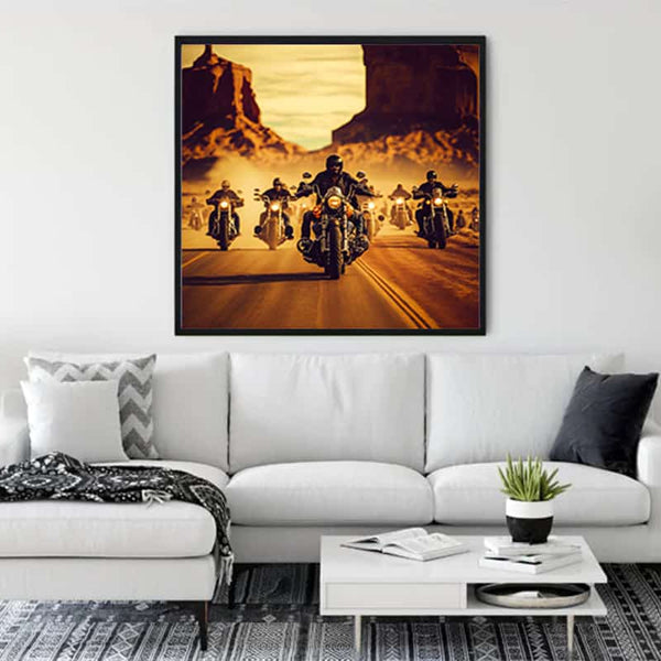 Modern living room with a stylish sofa, wall art of bikers on a desert road, indoor plant, and contemporary decor elements.