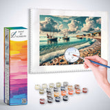 Paint by Numbers kit Coastal Whispers with Mediterranean fishing village scene and pastel skies reflecting on crystal clear waters.