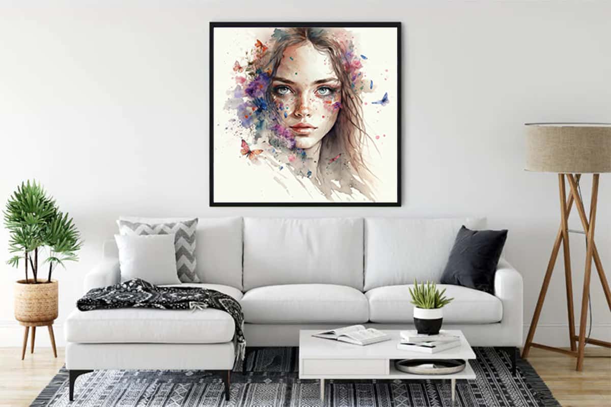Diamond painting of an elegant woman's face hanging on a wall above a modern white couch in a stylish living room.