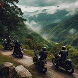 Bikers riding motorcycles on a scenic mountain road surrounded by lush greenery and misty hills.