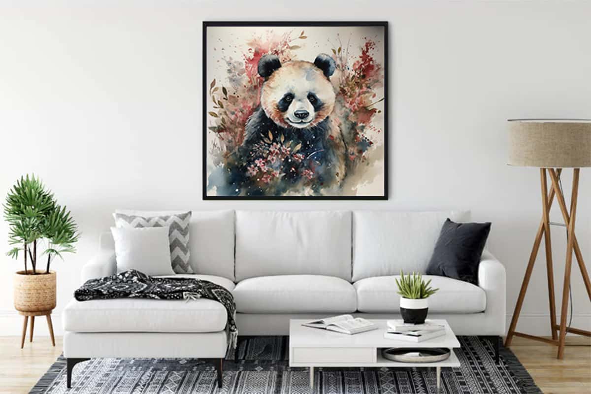 Diamond Painting - Fluffy Panda Bear framed on a living room wall behind a white sofa.