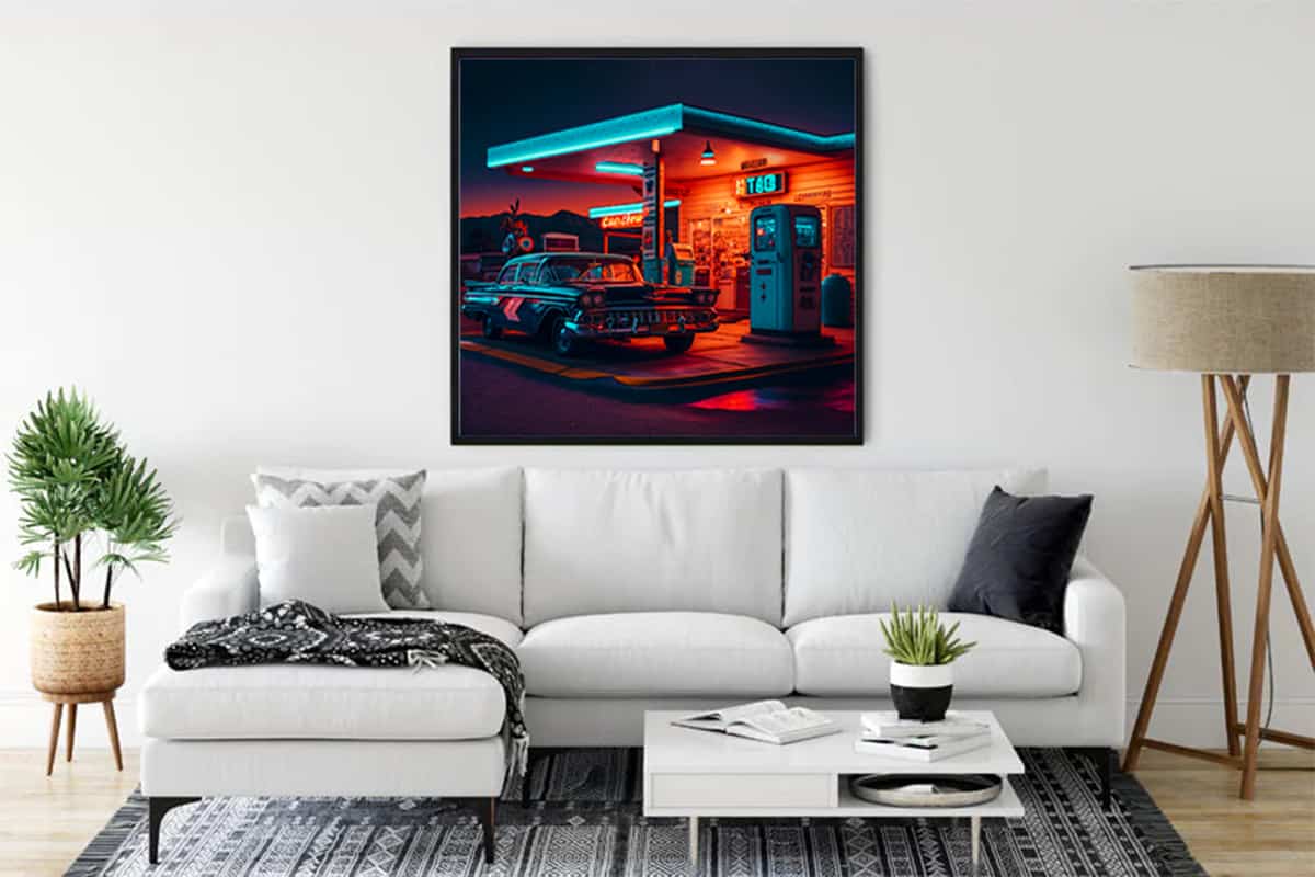 Diamond painting of a 50s gas station romance scene displayed above a modern white sofa in a stylish living room.