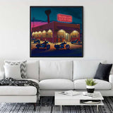 Diamond Painting - Adventure Rider displayed in a modern living room, showcasing a vibrant scene of motorcycles outside a diner at night.