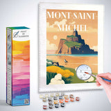 Paint by Numbers kit featuring the serene Mont-Saint-Michel landscape with a person painting, paint pots, and brush included.