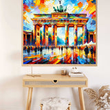Paint by Numbers - an abstract colorful depiction of the Brandenburg Gate with bold blue, orange, and red brushstrokes hanging above a wooden desk.