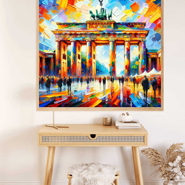 Paint by Numbers - an abstract colorful depiction of the Brandenburg Gate with bold blue, orange, and red brushstrokes hanging above a wooden desk.