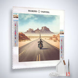 Diamond Painting Kit with a biker on a desert highway, showcasing Professional Canvas, Acrylic Diamonds, Tweezers, and Application Pen.