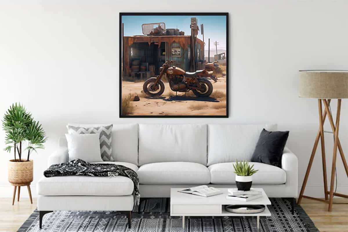 Living room with a framed diamond painting of an offroad motorcycle and rustic shack on white wall above a white sofa.