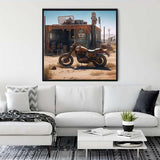 Living room with a framed diamond painting of an offroad motorcycle and rustic shack on white wall above a white sofa.