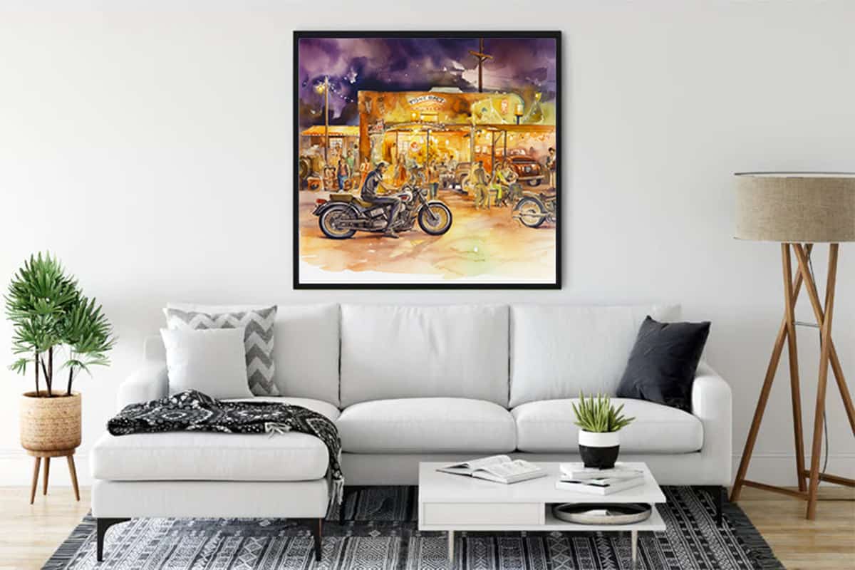 Living room with white sofa featuring a vibrant canvas painting of motorcycles and retro ambiance, enhancing the modern decor.