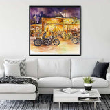 Living room with white sofa featuring a vibrant canvas painting of motorcycles and retro ambiance, enhancing the modern decor.