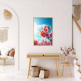 Diamond Painting - Spring Dreams displayed in a modern living room, featuring blooming pink flowers against a bright blue sky.