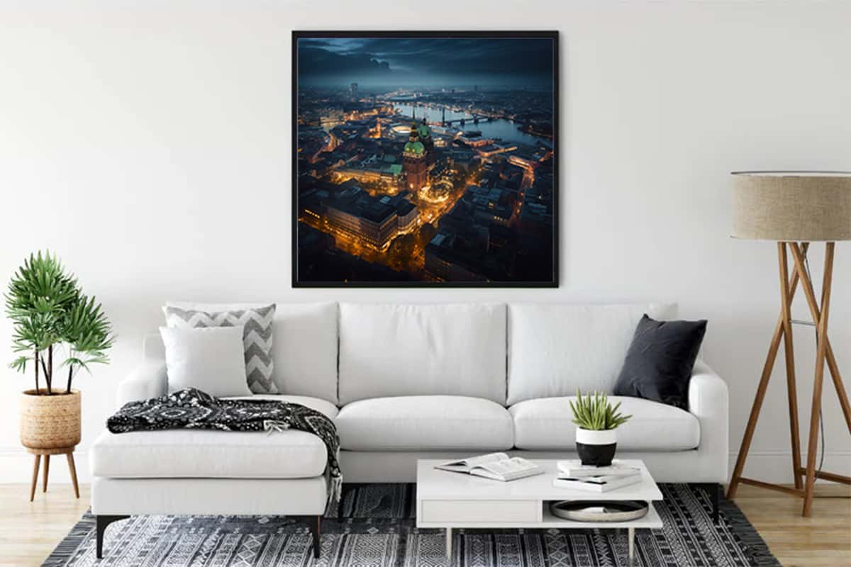 Diamond Painting of Hamburg from above displayed in a modern living room with white couch and plants. Paint by Numbers.