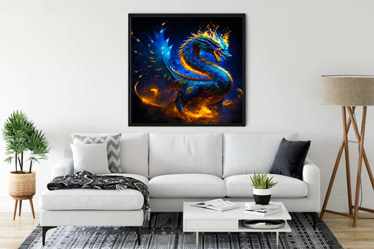 Diamond Painting of a vibrant blue dragon set against a fiery background, showcased in a stylish living room above a white couch.
