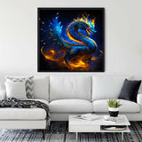 Diamond Painting of a vibrant blue dragon set against a fiery background, showcased in a stylish living room above a white couch.