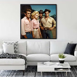 Diamond painting of four friends on a wall above a modern white sofa in a stylish living room.