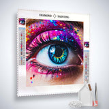 Close-up of a colorful eye design on a Diamond Painting canvas with acrylic diamonds, application tools, and Paint by Numbers kit.