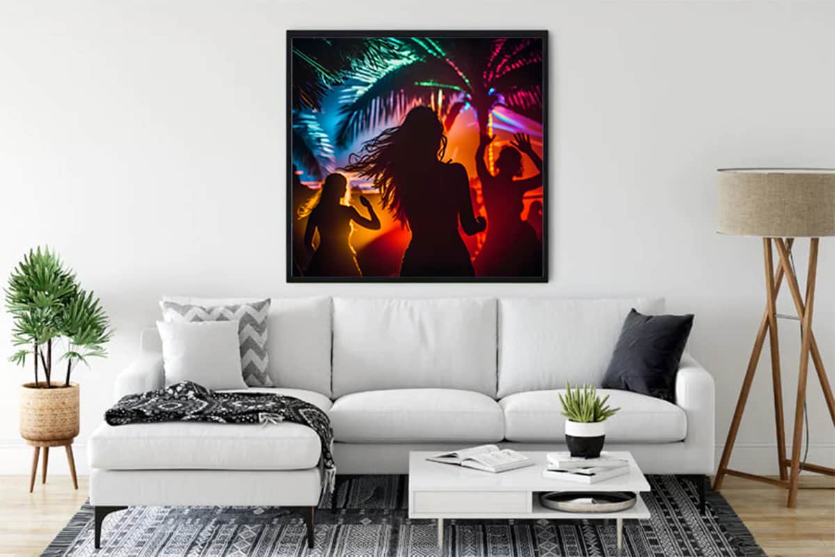 Diamond Painting - The Beach Dance artwork displayed in a living room, featuring colorful silhouettes dancing under palm trees with vibrant lights.