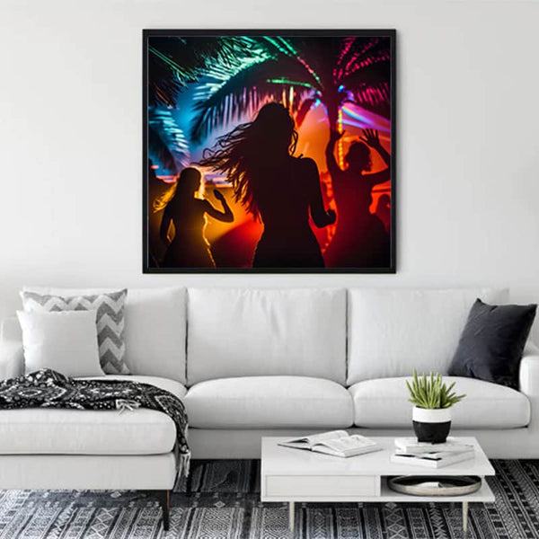 Diamond Painting - The Beach Dance artwork displayed in a living room, featuring colorful silhouettes dancing under palm trees with vibrant lights.